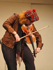 Tune-up: Getting ready for a performance, Cathy Reckenberg tunes her instrument. (Photo courtesy Robert Colasanto)